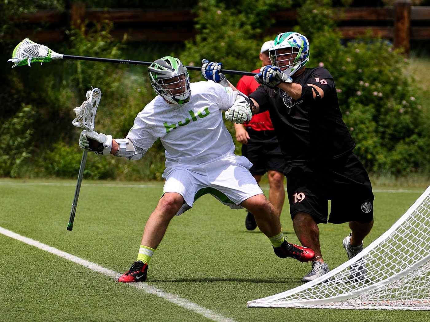 Mission section athlete action image showing competitive lacrosse play